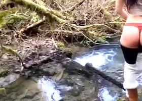 Hiker Removes Pants by the Stream
